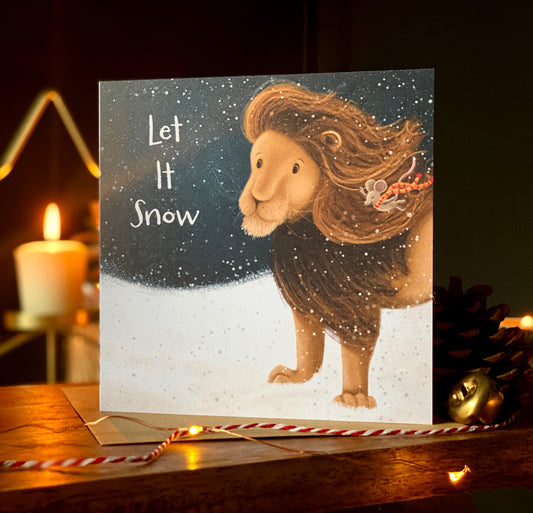 A square Christmas card showing an illustration of a lion and a mouse walking through a blizzard against a night lit sky. 